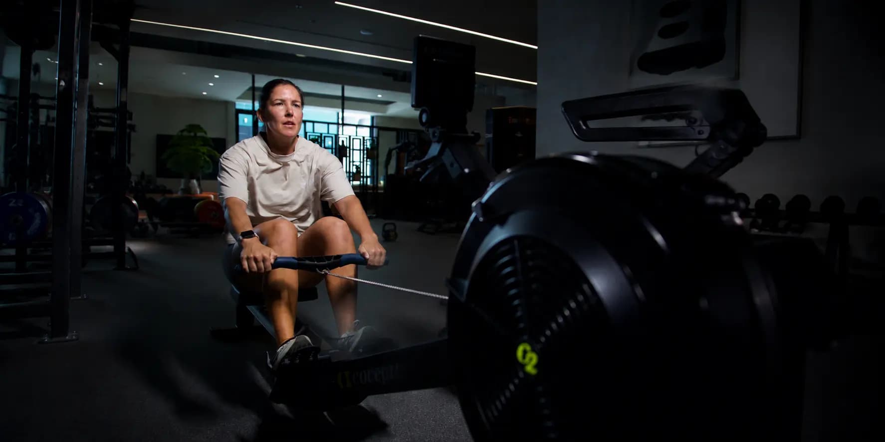 Athlete training on a rowing machine as part of HYROX race preparation.